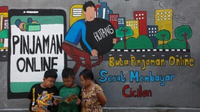 Sejumlah anak membaca bersama di dekat dinding bermural di kawasan Tempurejo, Surabaya, Jawa Timur, Selasa (7/9). Foto: Ist