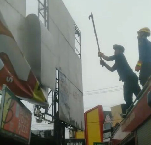 Petugas Damkar Depok memperbaiki papan reklame yang rusak di Depok. Dok. Tangkapan Layar Video